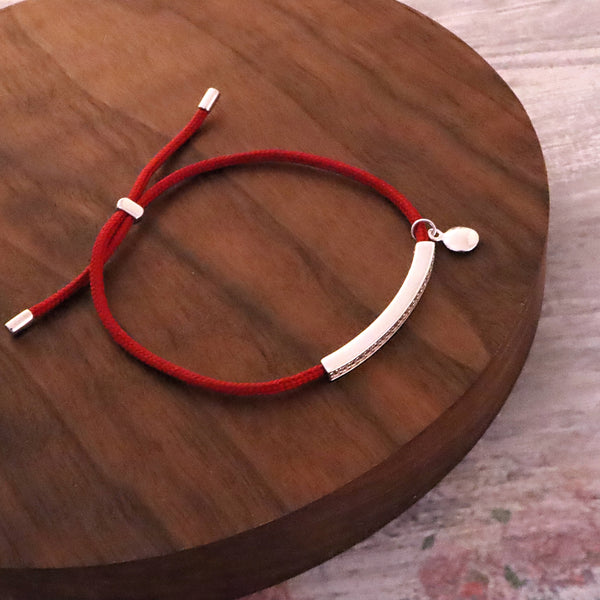 Red String Bracelet with Silver Adornment